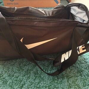 Nike Black Duffel Bag with White Swoosh and Logo Strap
